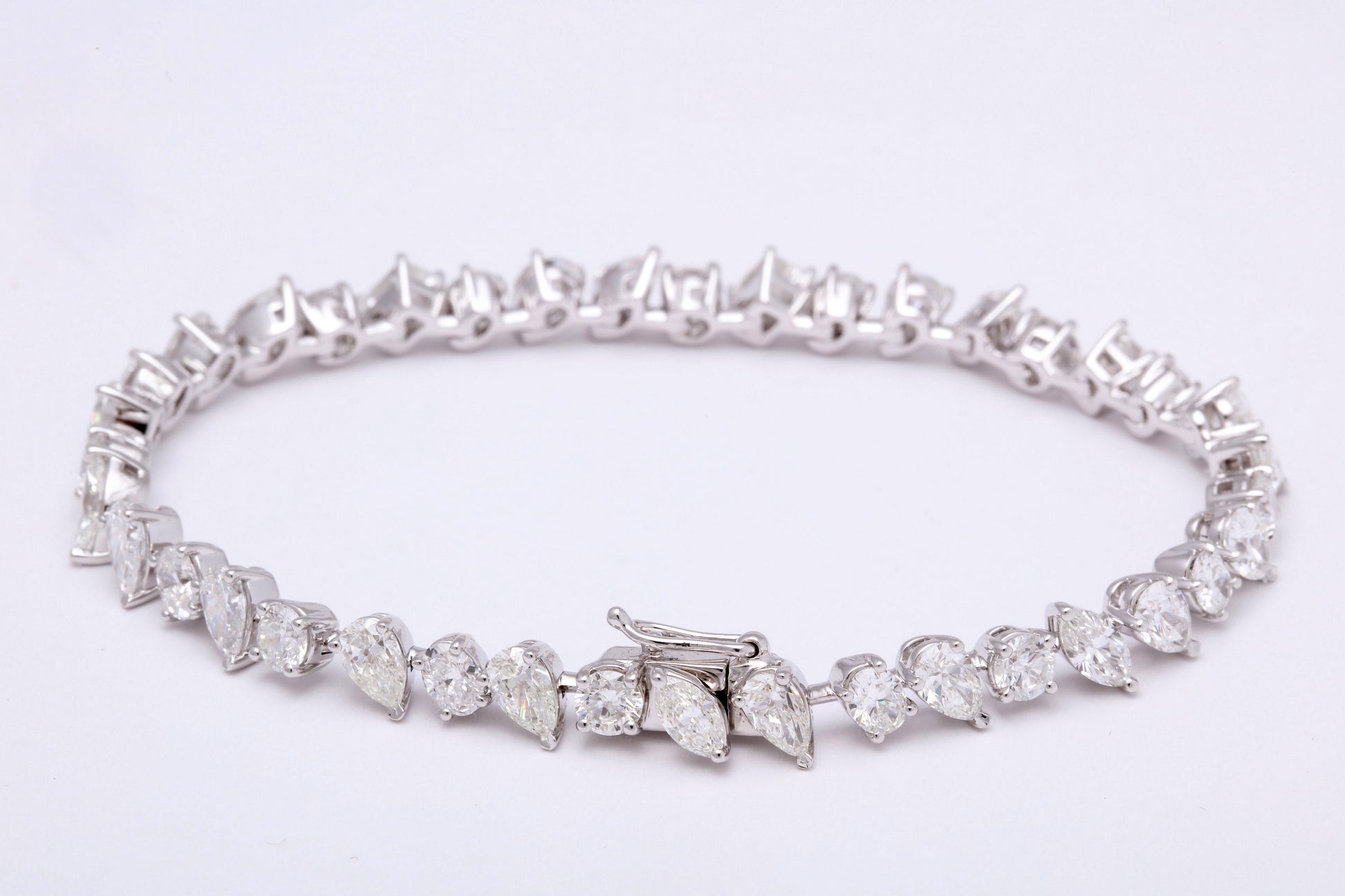 https://a.1stdibscdn.com/multi-shape-diamond-tennis-bracelet-for-sale-picture-5/366869/j_57882221553111221029/6R1A3403_org_master.jpg