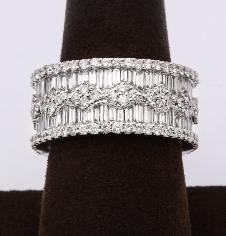 https://a.1stdibscdn.com/wide-baguette-and-round-diamond-band-for-sale-picture-4/j_415/1606754927586/6R1A9891_master.jpg?width=768